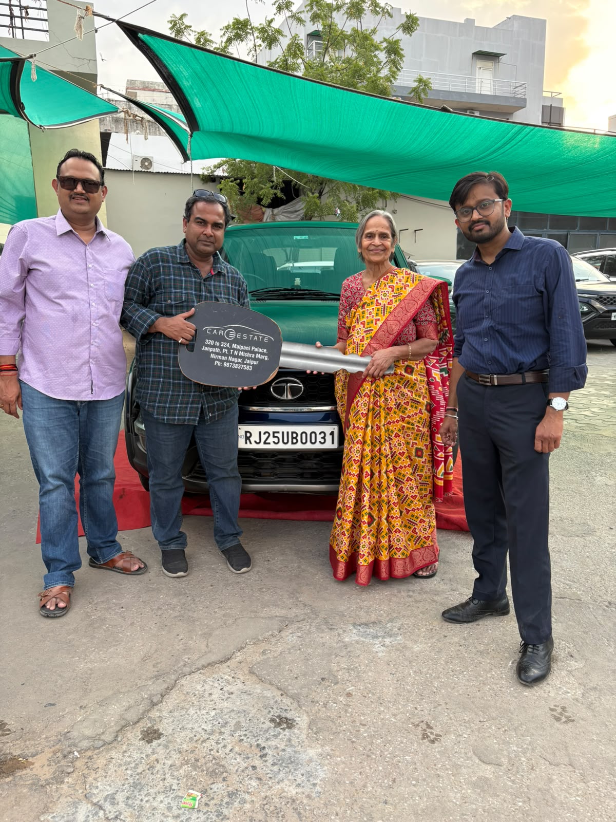Celebrating another happy customer driving away with their d